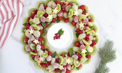 A Christmas Fruit Tray with sugared grapes and pomegranate with a yogurt fruit dip.