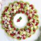 A Christmas Fruit Tray with sugared grapes and pomegranate with a yogurt fruit dip.