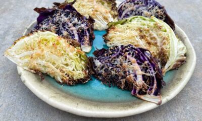 Six wedges Parmesan Roasted Cabbage Wedges on pottery serving plate.