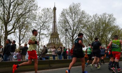 Participants run near the Eiffel Tower during the Paris Marathon 2024