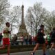 Participants run near the Eiffel Tower during the Paris Marathon 2024