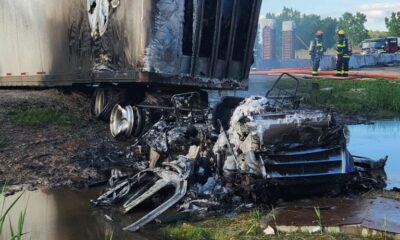 A semi-tractor trailer caught fire early Wednesday morning after colliding with a concrete barrier and then sliding across Interstate-41.