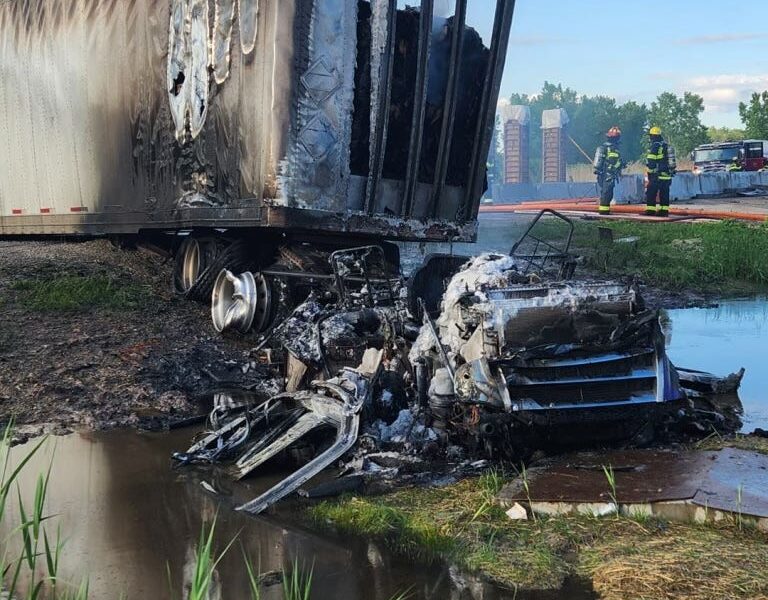 A semi-tractor trailer caught fire early Wednesday morning after colliding with a concrete barrier and then sliding across Interstate-41.