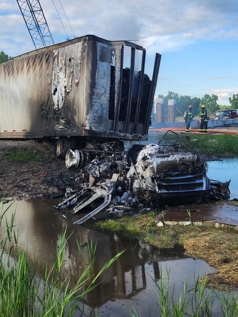 A semi-tractor trailer caught fire early Wednesday morning after colliding with a concrete barrier and then sliding across Interstate-41.