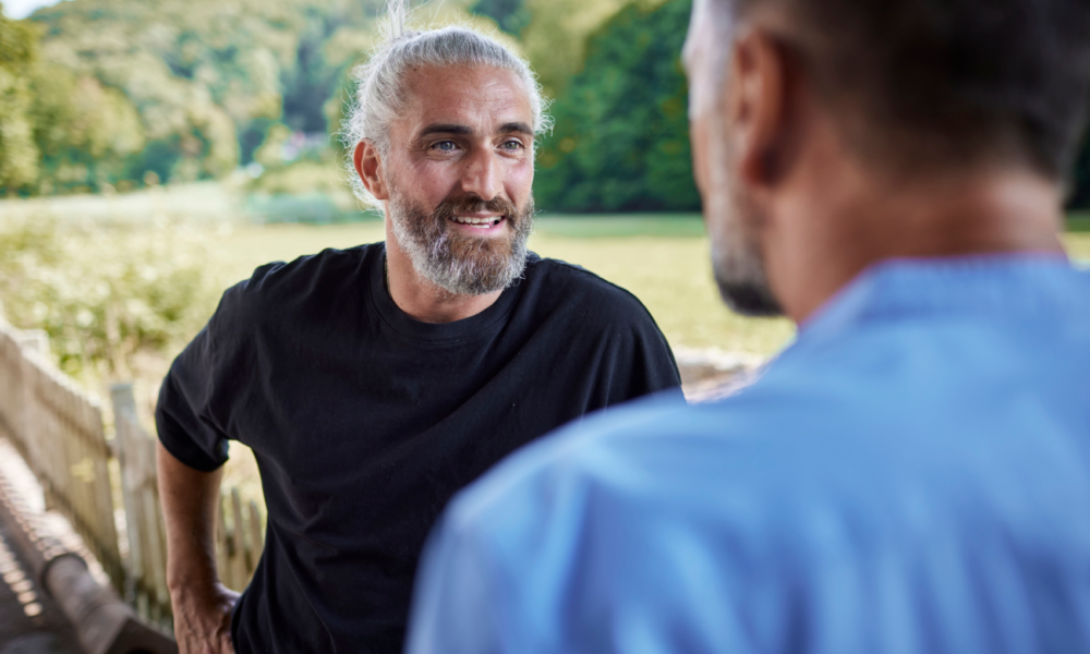 Man talking to friend outside