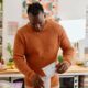 Man pouring protein powder into beaker