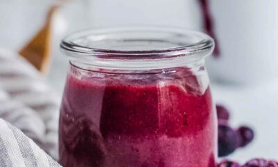 Blueberry puree for baby served in a glass jar.