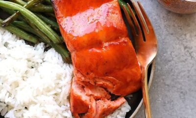 honey sriracha salmon on plate with rice and green beans and fork