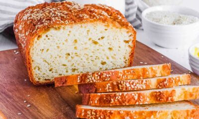 Healthy, low-calorie gluten free bread recipe, baked and sliced on a cutting board.