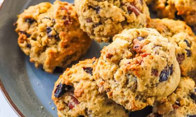 Dried fruit cookies stacked on a blue plate.