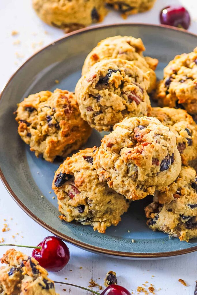 Dried fruit cookies stacked on a blue plate.