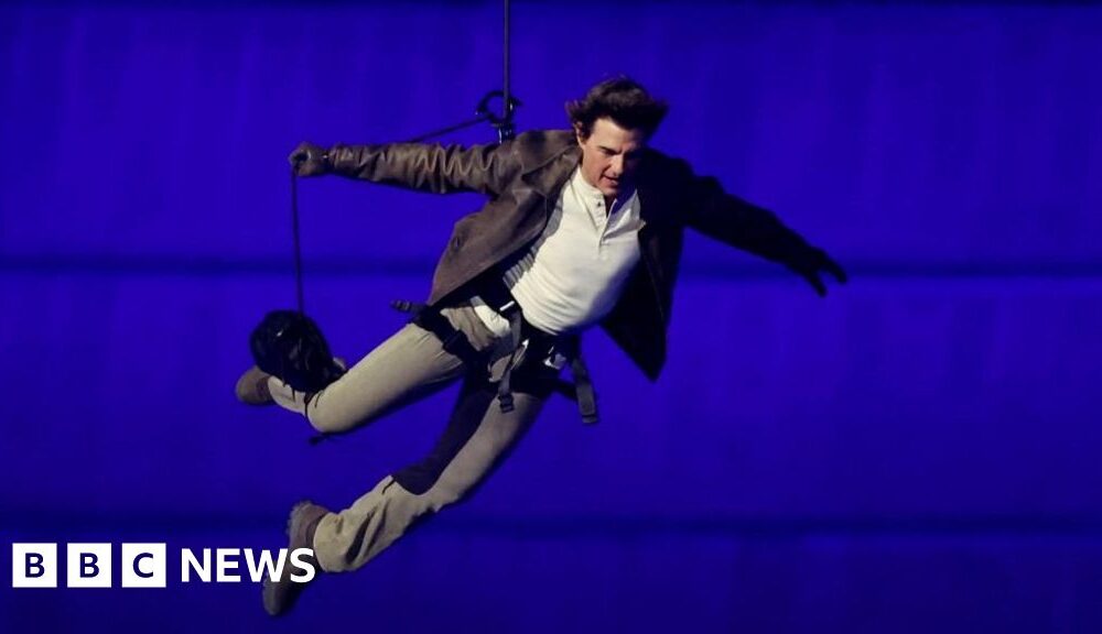 Tom Cruise abseils off stadium roof in daring Olympic finale