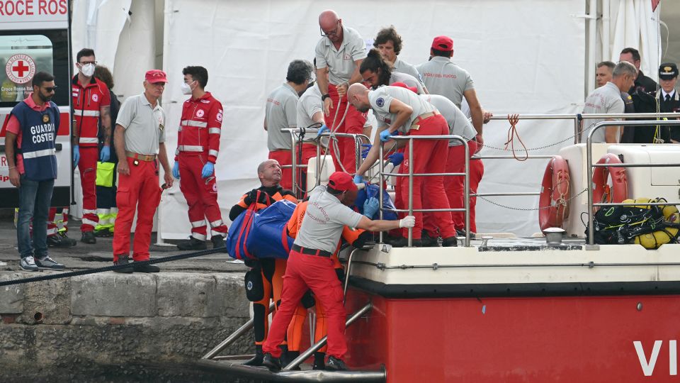 Rescuers carry a body after divers return to Porticello harbor near Palermo, three days after the British-flagged luxury yacht Bayesian sank. - Alberto Pizzoli/AFP/Getty Images