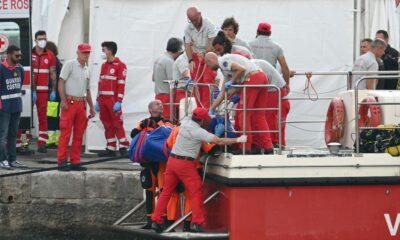 Rescuers carry a body after divers return to Porticello harbor near Palermo, three days after the British-flagged luxury yacht Bayesian sank. - Alberto Pizzoli/AFP/Getty Images